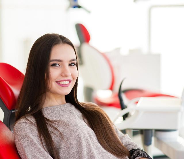 Smiling woman in a dental chair.