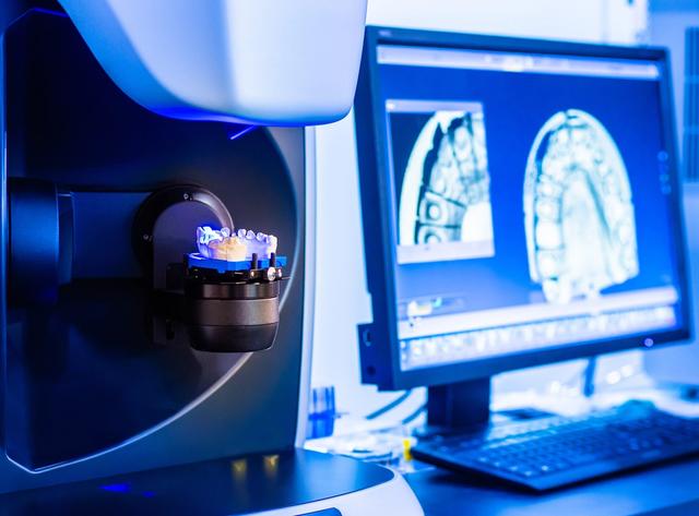 a computer monitor is displaying a picture of a dental model .