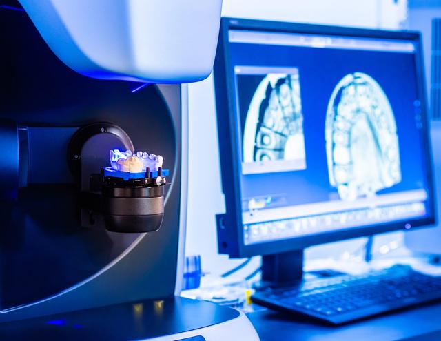 a computer monitor is displaying a picture of a dental model .