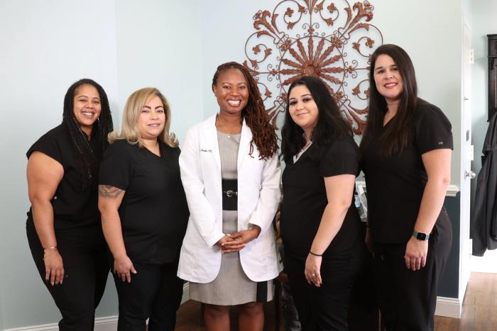 a group of women are posing for a picture together in a room .