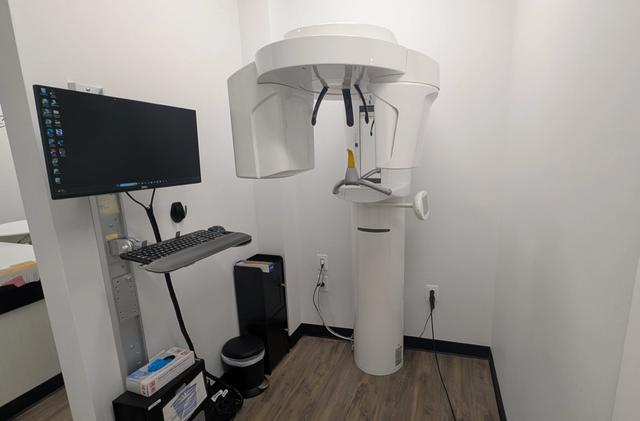 a dental office with a computer and a x-ray machine .