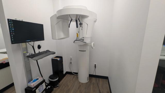 a dental office with a computer and a x-ray machine .