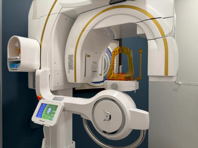 a dental office with a dental chair and a television on the wall .