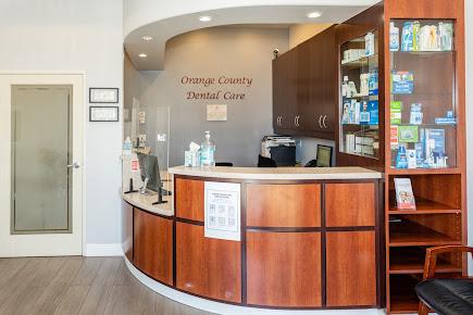 a dental office with a wooden reception desk and shelves filled with dental supplies .