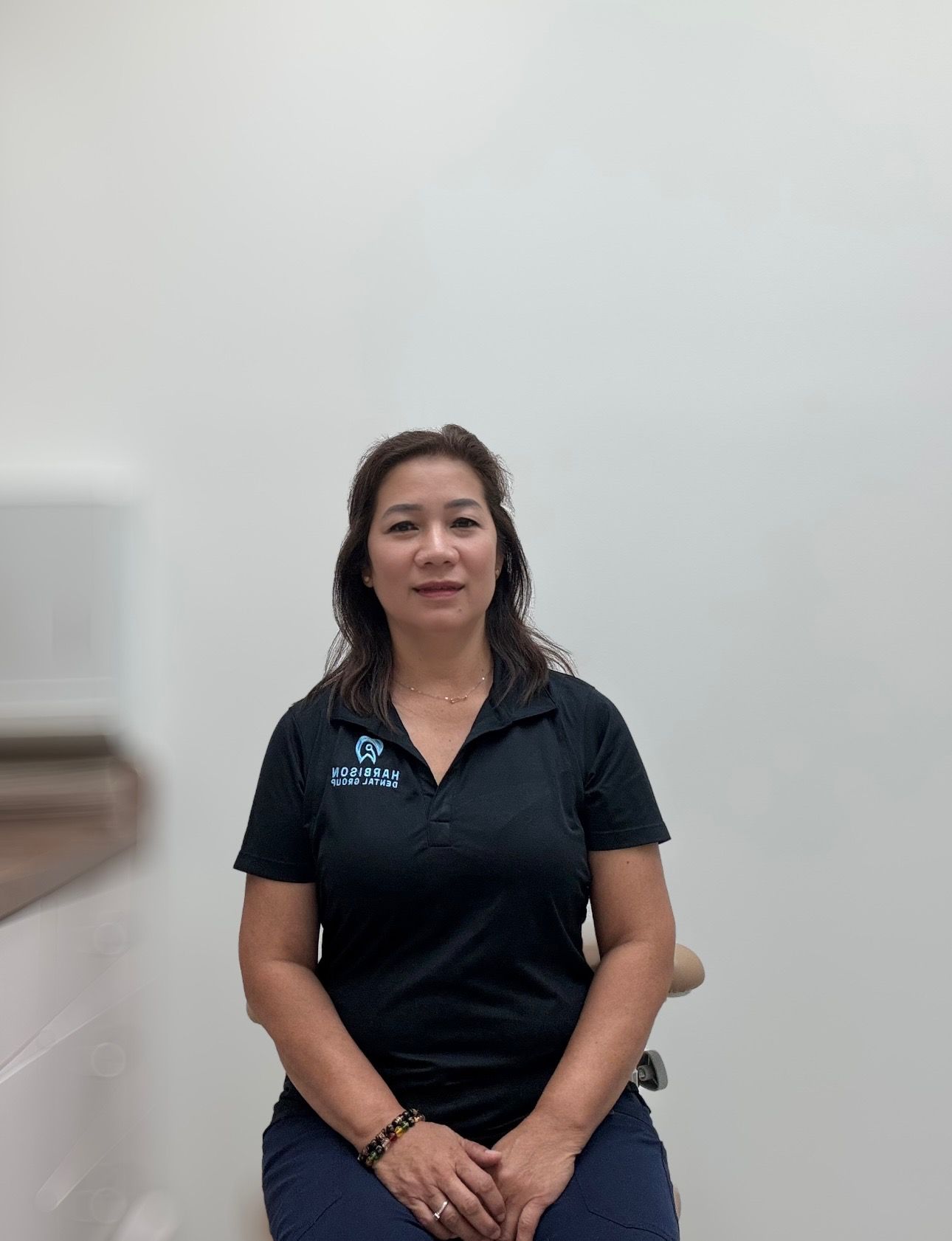 a woman is sitting on a chair wearing a black shirt .