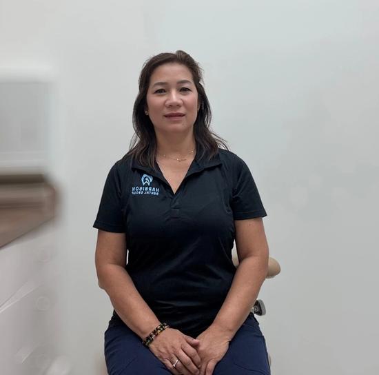 a woman is sitting on a chair wearing a black shirt .