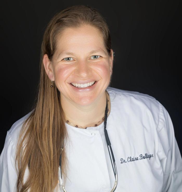 a man with a beard is smiling while sitting on a couch .