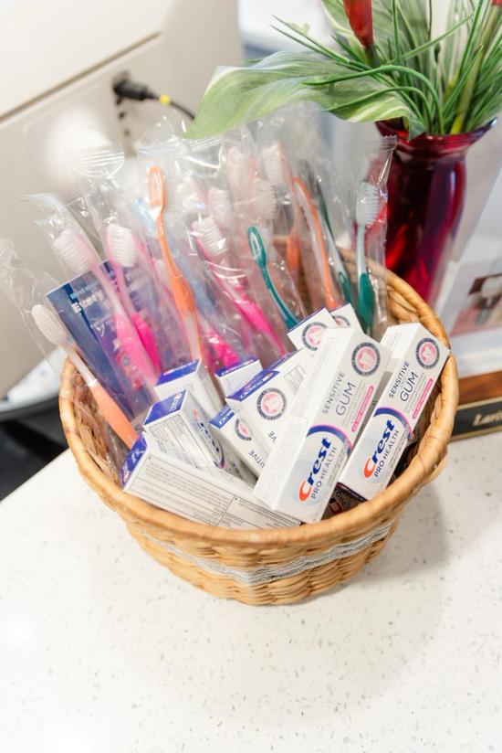 a basket filled with toothbrushes and crest gum toothpaste