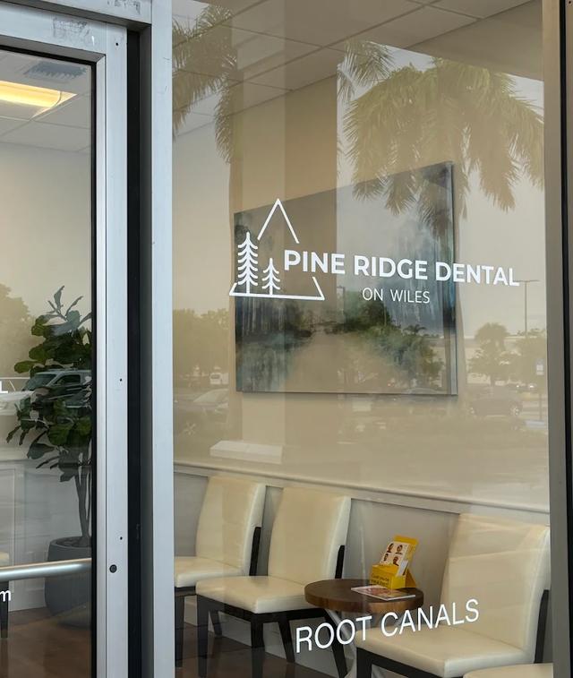 pine ridge dental on wiles has a waiting room with chairs and a table .