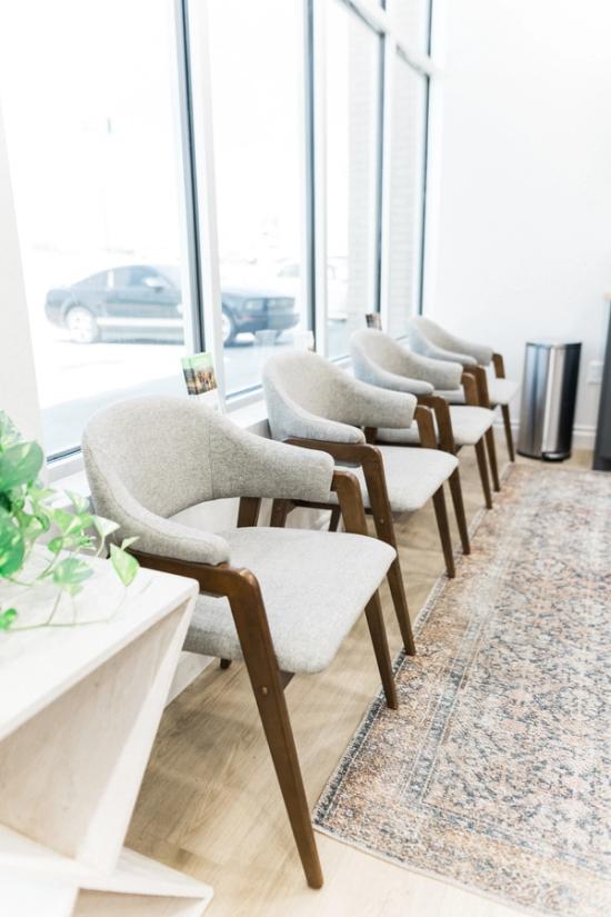a row of chairs in a waiting room next to a window