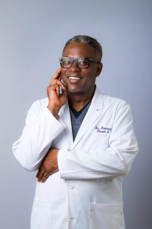 a man in a lab coat with the name dr. anthony dental on it