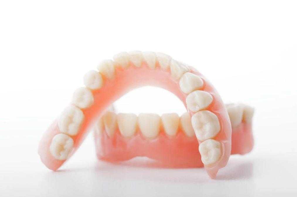 a close up of a pair of dentures on a white surface .