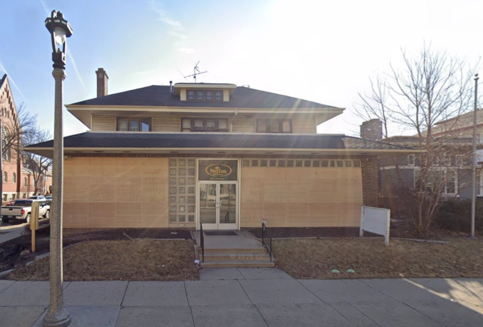 a waiting room with blue chairs and a white counter in a dental office .