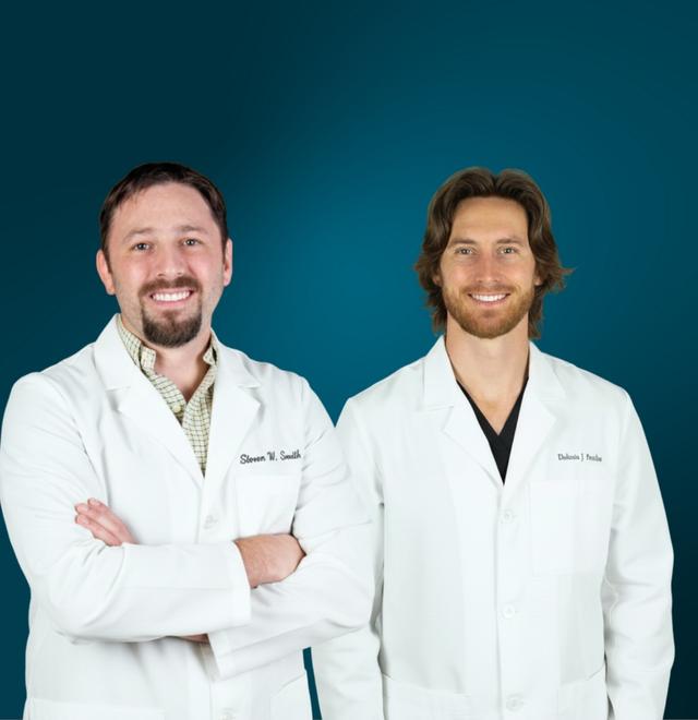 Two smiling men, Steven W. Smith and Dakota J. Smith, in white lab coats.