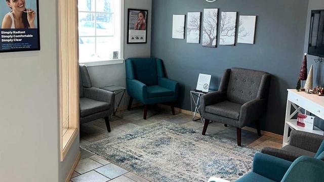 a waiting room with chairs and a rug in a dental office .