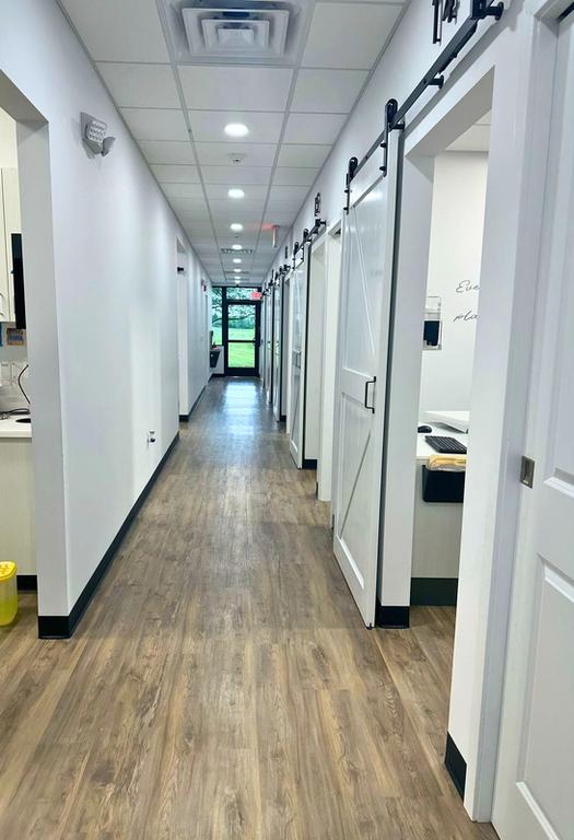 a long hallway in a dental office with sliding barn doors