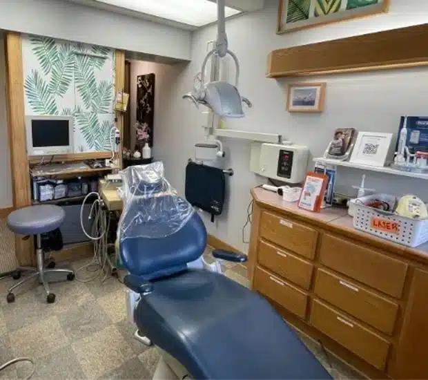 a dental office with a dental chair and a computer .