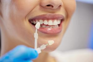 a woman is getting her teeth examined by a dentist .