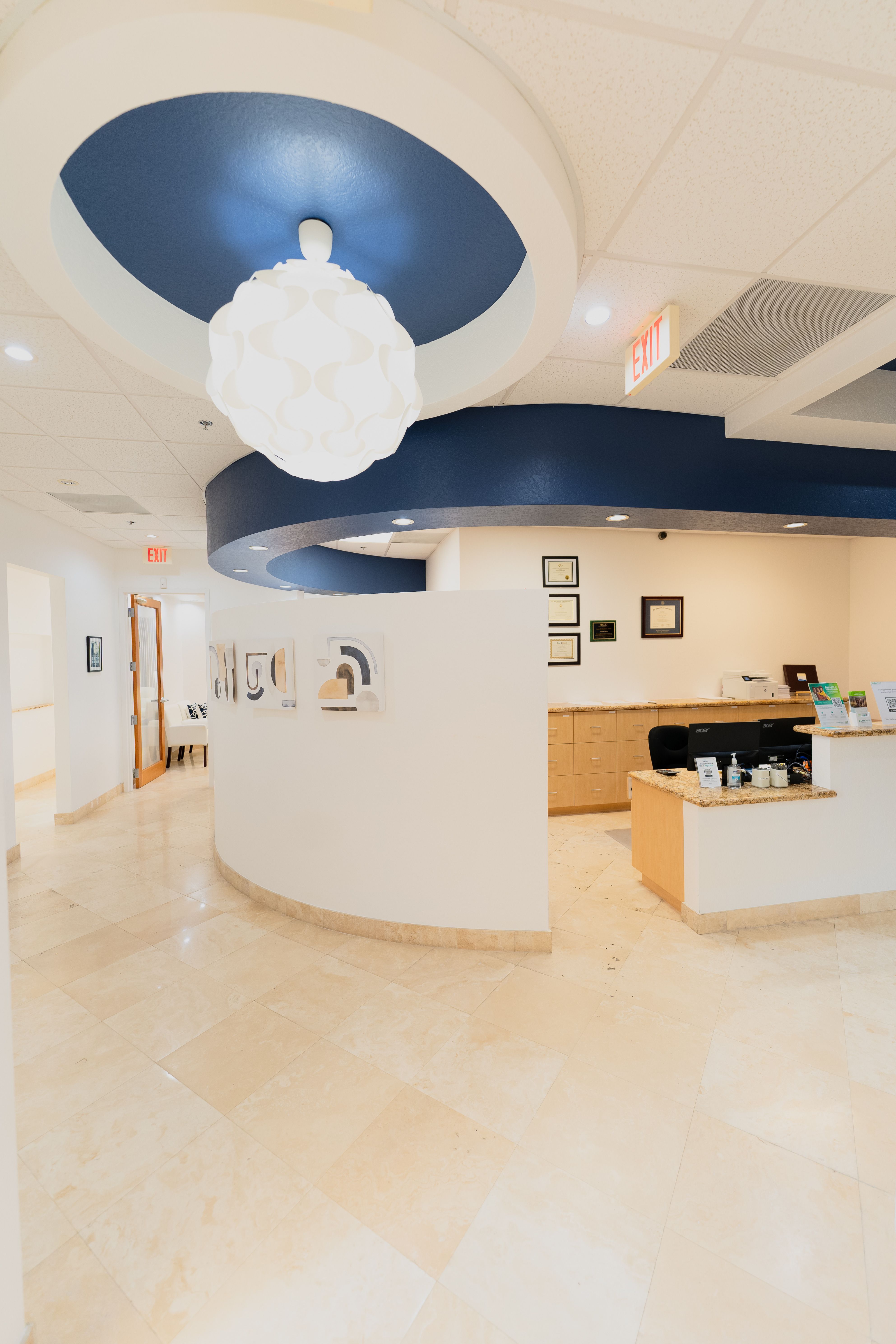 a white exit sign is above a curved wall