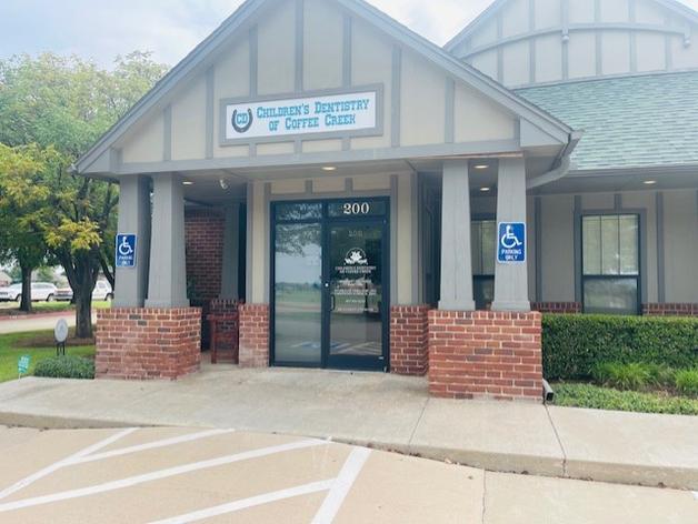 a brick building with a handicapped parking spot in front of it .