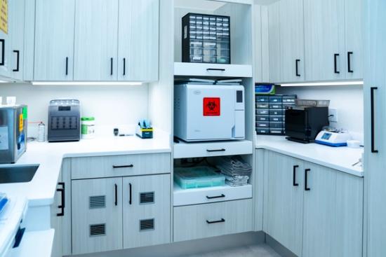 Modern sterilization room with an autoclave and various lab equipment.
