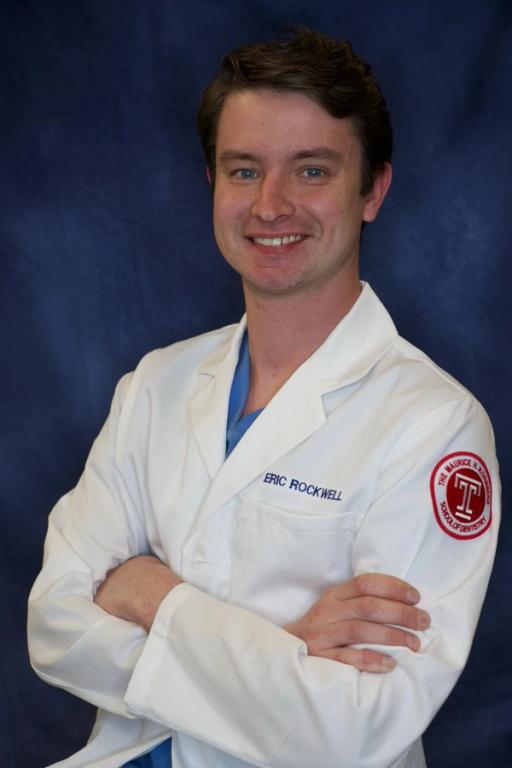 a man in a lab coat with the name eric rockwell on it