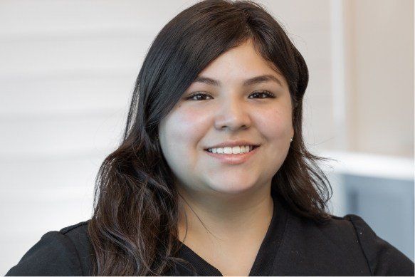 a woman in a black shirt is smiling for the camera .