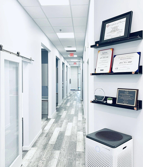 a hallway with a few certificates on the wall including one that says diploma