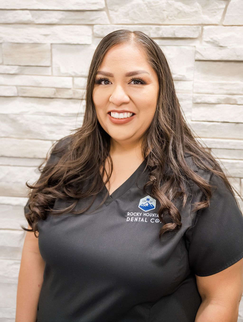 a woman wearing a black shirt that says rocky mountain dental co.