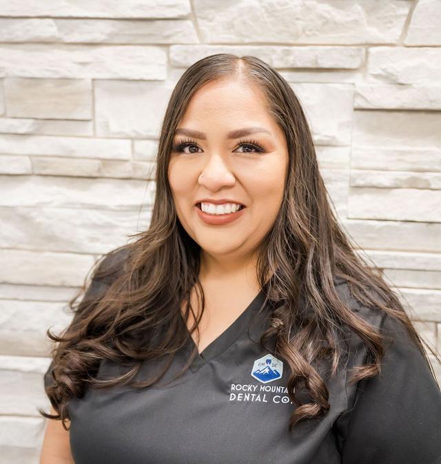 a woman wearing a black shirt that says rocky mountain dental co.