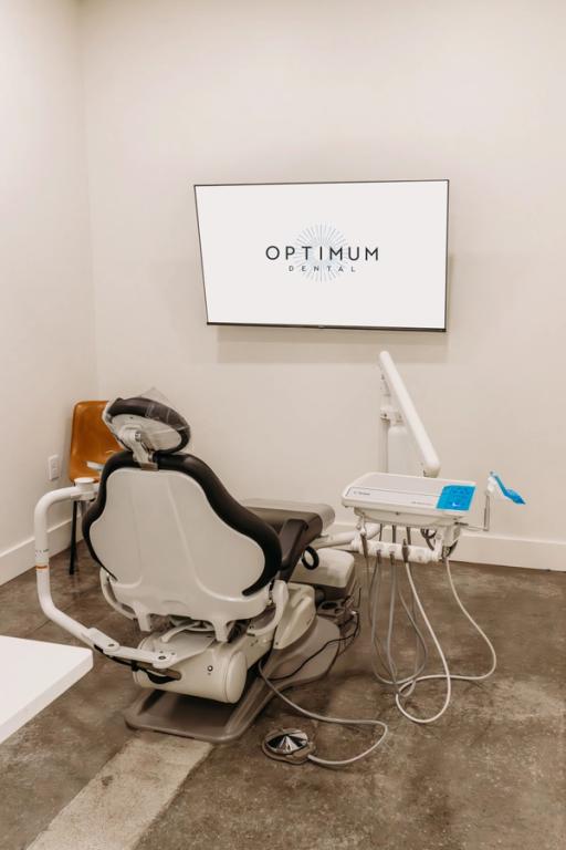 a dental office with an optimum dental sign on the wall