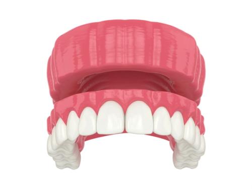 a 3d rendering of a denture with white teeth on a white background .