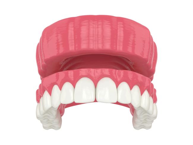 a 3d rendering of a denture with white teeth on a white background .