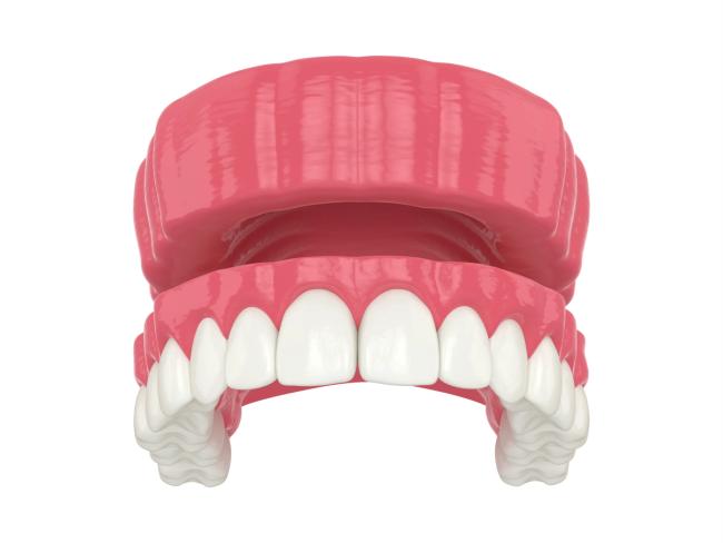 a 3d rendering of a denture with white teeth on a white background .