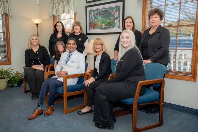 a group of people are sitting in chairs in a waiting room .