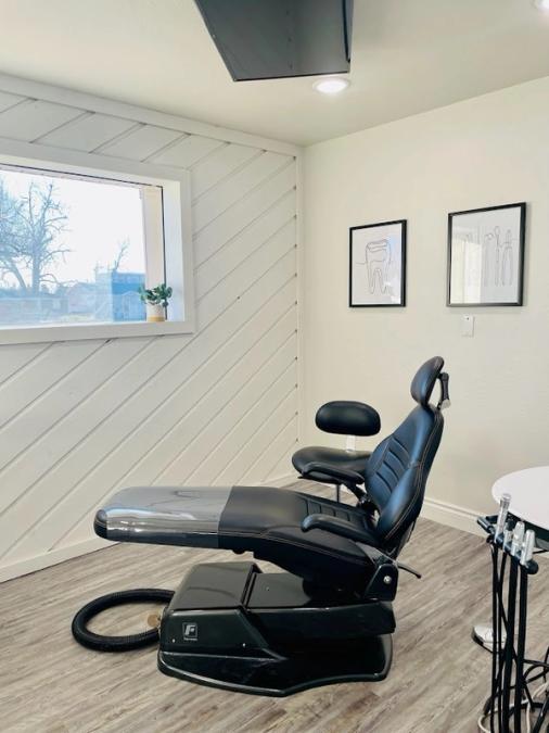a black dental chair in a dental office