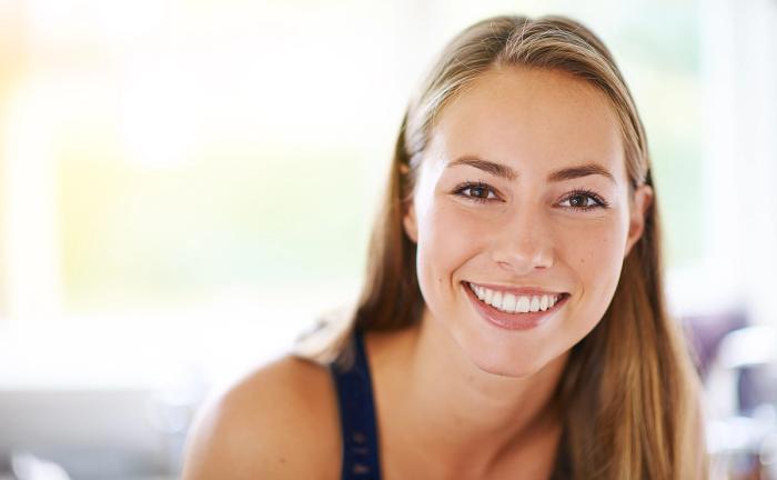 a close up of a woman smiling for the camera .