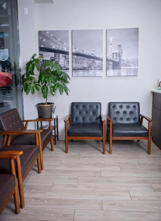a waiting room with chairs and paintings on the wall