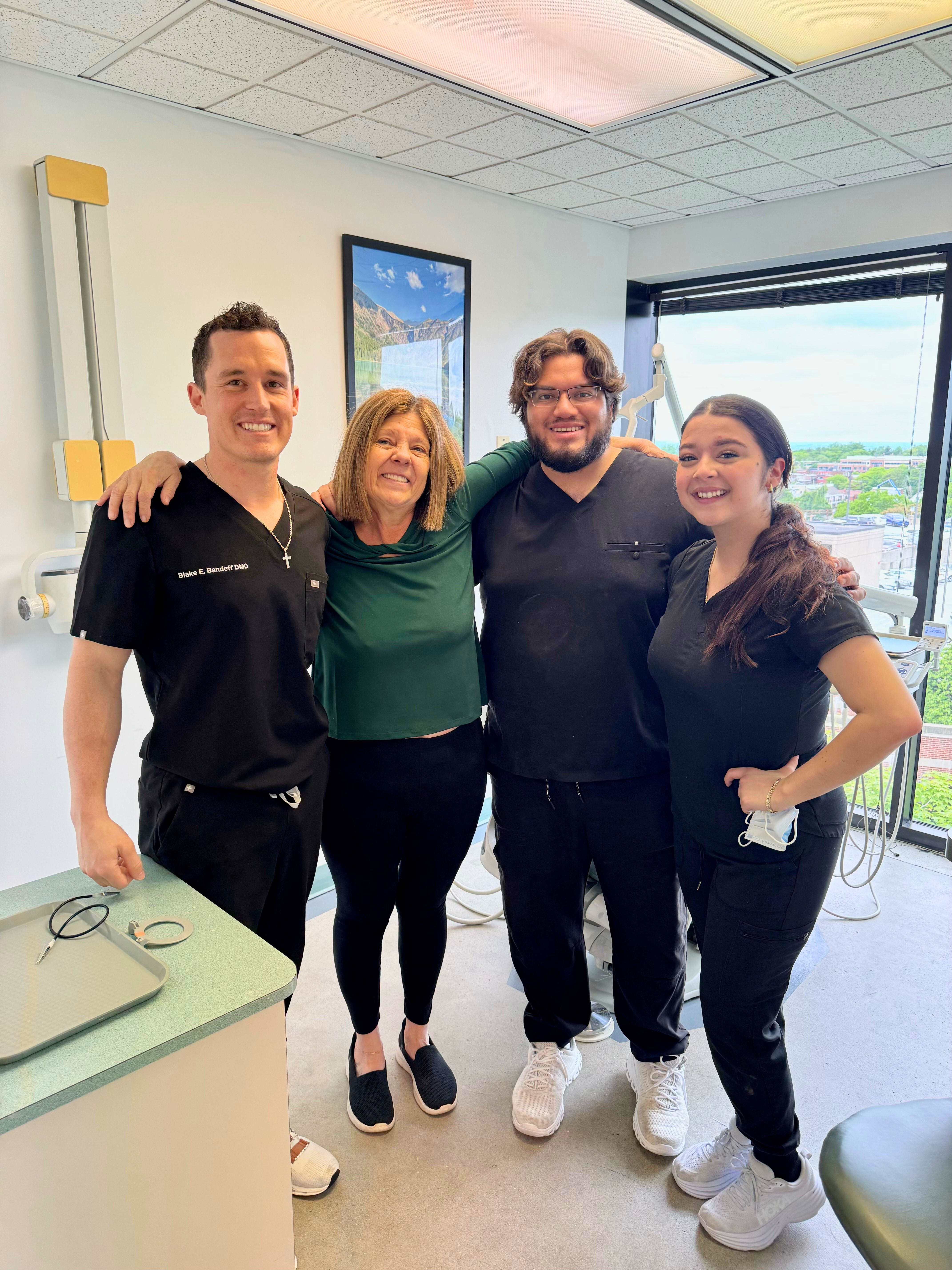a woman wearing glasses is smiling in an empty room .