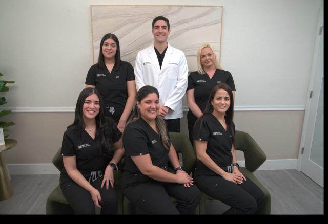 a group of dentists are posing for a picture together .