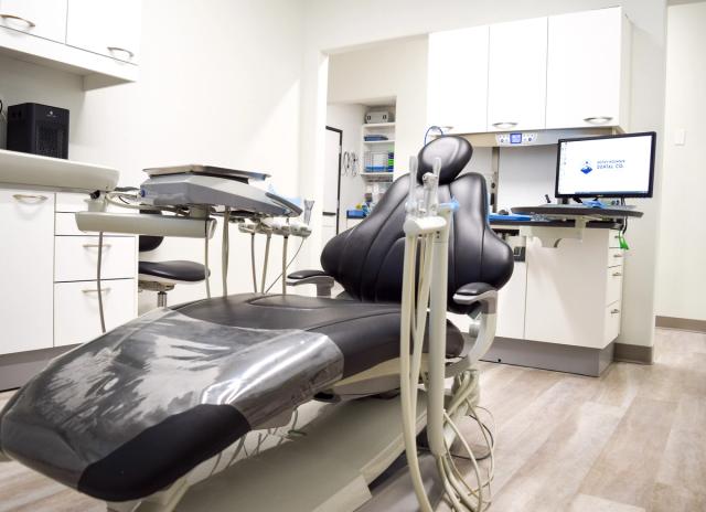 a dental office with a dental chair and a computer .