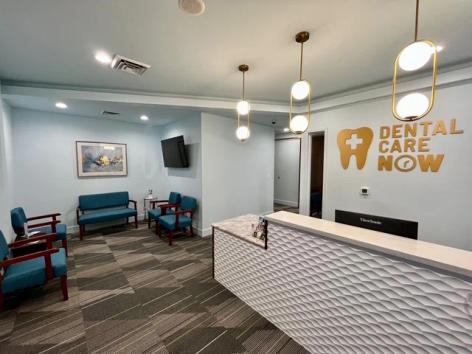 a dental office with a waiting room and a reception desk .