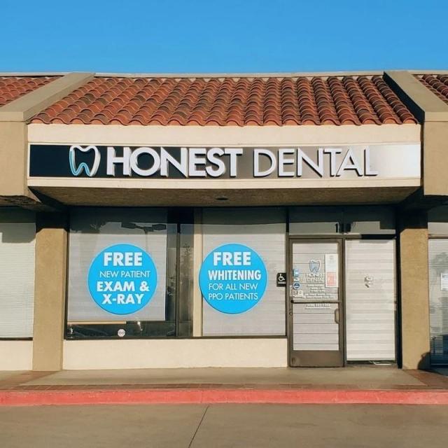 the front of a dental office with a sign that says `` free whitening for all new pro patients '' .