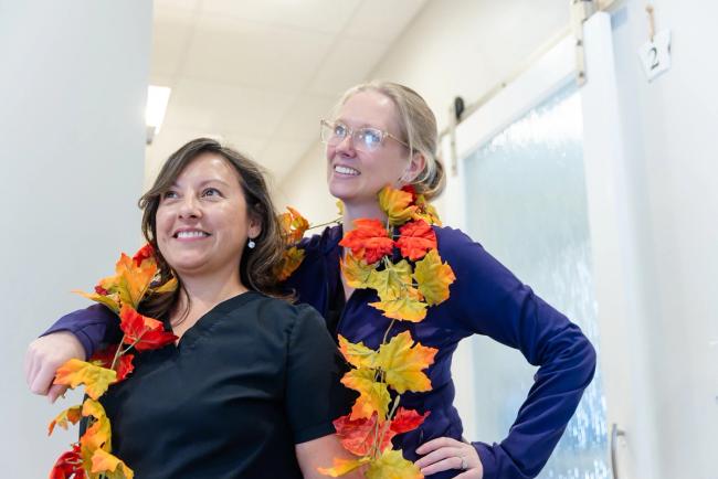 a woman is holding a tooth color chart in front of her mouth .
