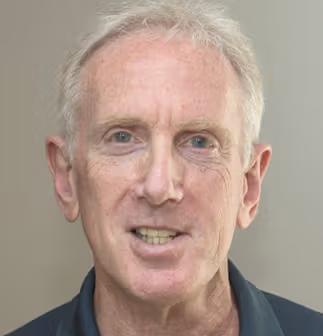 a close up of a man 's face with a smile on his face .