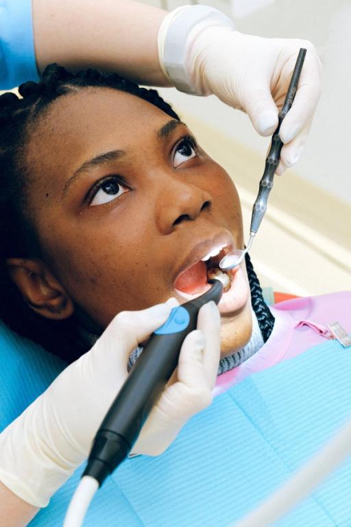 a close up of a tooth being extracted by a pair of pliers