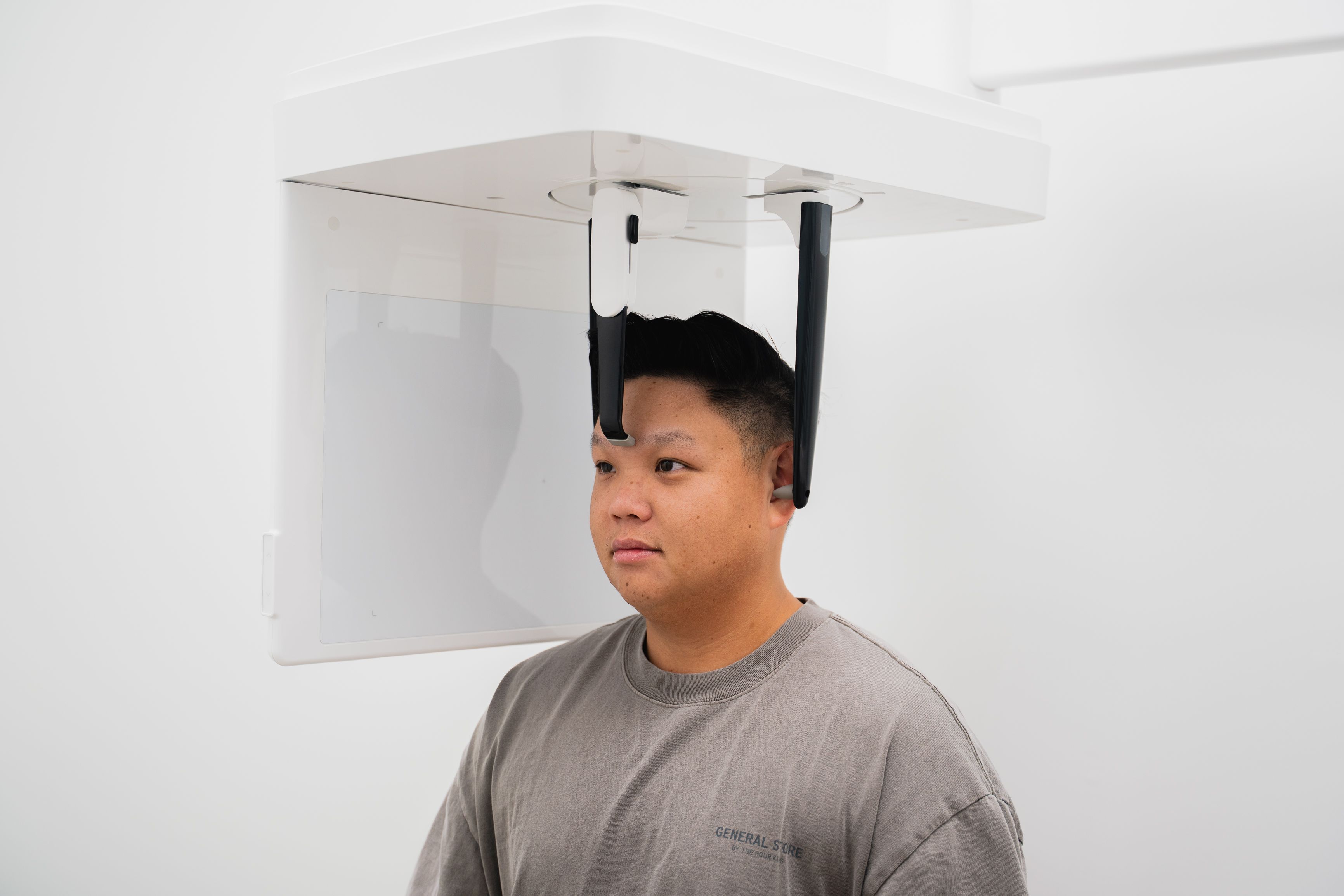 Man positioned in a dental panoramic x-ray machine.
