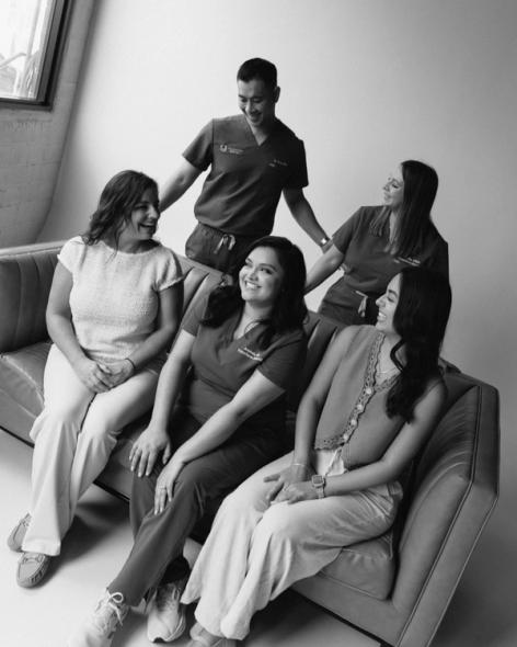 a group of people sitting on a couch with one wearing a scrub that says ucsd
