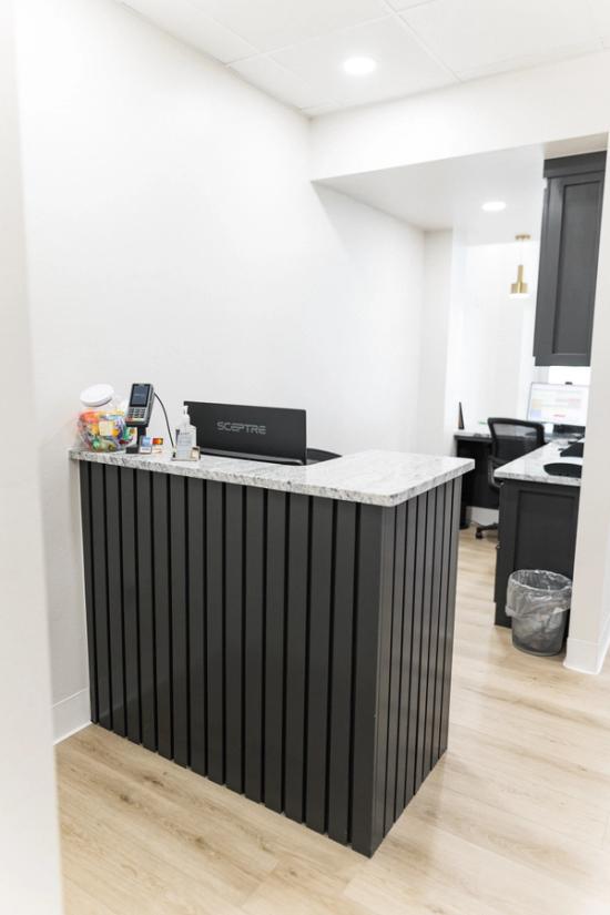 a group of four men in black scrubs are standing next to each other .