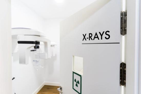 there is a sign on the wall that says `` x-rays '' .